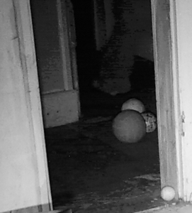 Image of "Jonathan" behind balls beyond door frame.